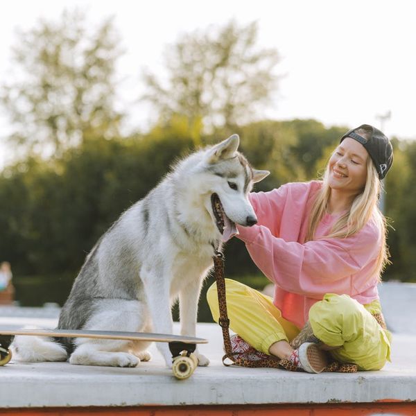 Woman feeling energetic and happy outdoors in a sunny park.